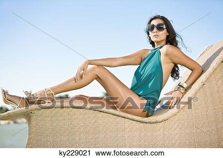 Woman posing on a chaise longue View Large Photo Image Stock Image - Woman posing on a chaise longue. Fotosearch