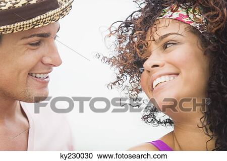 Close-up of a couple smiling at each other View Large Photo Image Stock Image - Close-up of a couple smiling at each other. Fotosearch