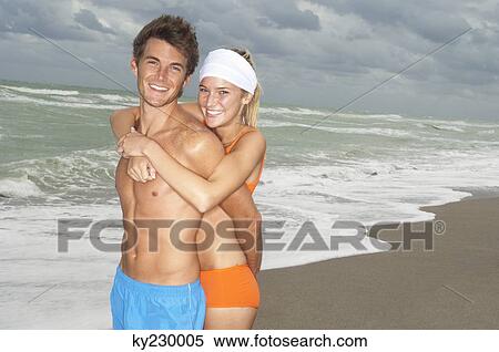 Couple embracing on the beach View Large Photo Image Stock Photography - Couple embracing on the beach. Fotosearch