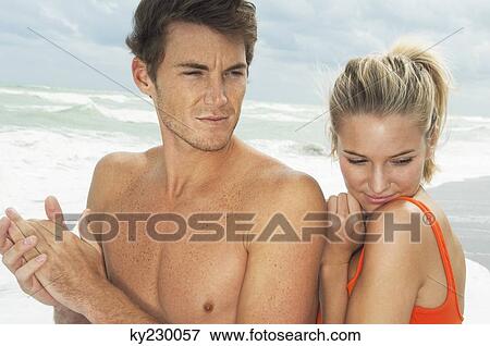 Couple on the beach View Large Photo Image Stock Photo - Couple on the beach. Fotosearch