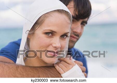 Couple smiling on the beach View Large Photo Image Stock Image - Couple smiling on the beach. Fotosearch
