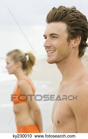 Couple standing on the beach View Large Photo Image Stock Image - Couple standing on the beach. Fotosearch