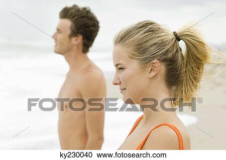 Couple standing on the beach View Large Photo Image Stock Image - Couple standing on the beach. Fotosearch
