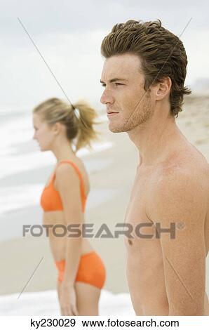 Couple standing on the beach View Large Photo Image Stock Photo - Couple standing on the beach. Fotosearch