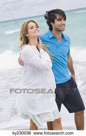 Couple walking on the beach View Large Photo Image Stock Photograph - Couple walking on the beach. Fotosearch