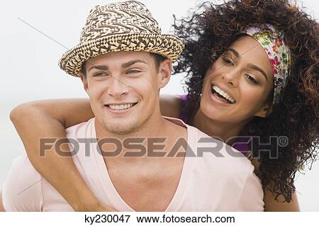 Man giving woman piggyback ride View Large Photo Image Stock Photo - Man giving woman piggyback ride. Fotosearch