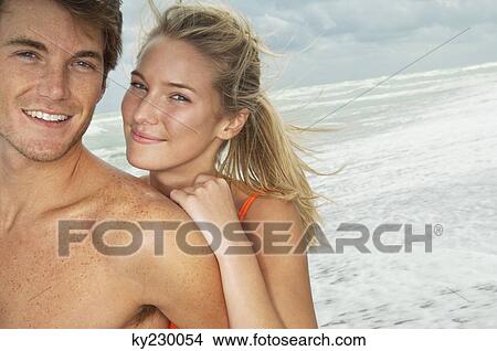 Portrait of a couple smiling on the beach View Large Photo Image Picture - Portrait of a couple smiling on the beach. Fotosearch
