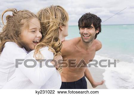 Couple giving piggyback ride to their children on the beach View Large Photo Image Stock Image - Couple giving piggyback ride to their children on the beach. Fotosearch
