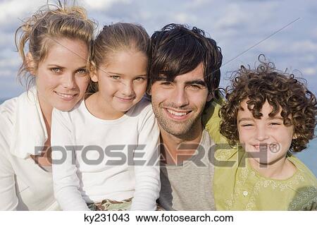 Portrait of a family smiling View Large Photo Image Stock Image - Portrait of a family smiling. Fotosearch