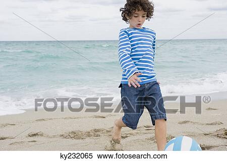 Boy playing on the beach View Large Photo Image Stock Photography - Boy playing on the beach. Fotosearch