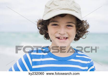 Boy smiling on the beach View Large Photo Image Stock Image - Boy smiling on the beach. Fotosearch