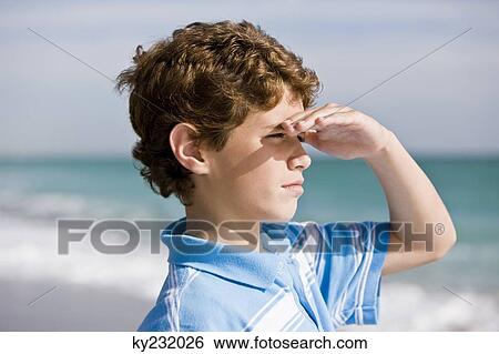 Close-up of a boy looking out to sea View Large Photo Image Stock Photograph - Close-up of a boy looking out to sea. Fotosearch