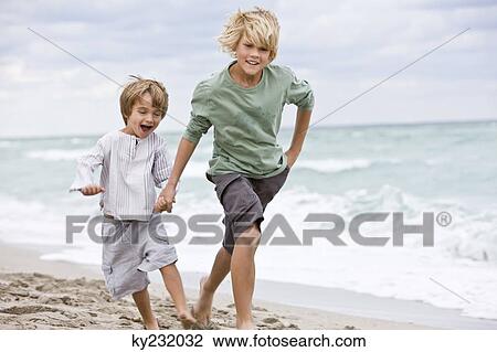 Two boys running on the beach View Large Photo Image Stock Image - Two boys running on the beach. Fotosearch