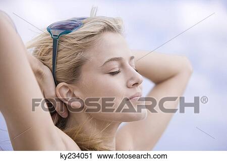 Close-up of a woman day dreaming View Large Photo Image Stock Image - Close-up of a woman day dreaming. Fotosearch