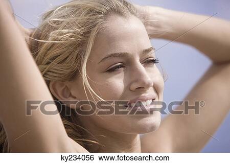 Stock Photograph - Close-up of a woman day dreaming. Fotosearch
