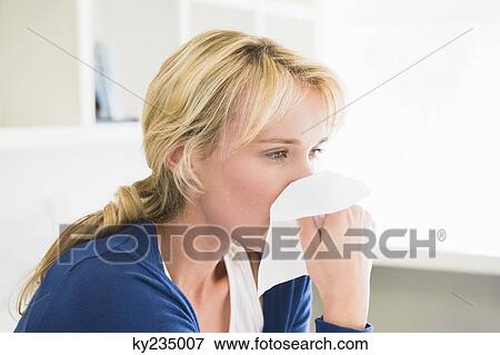 Close-up of a woman blowing her nose with a handkerchief View Large Photo Image Stock Photo - Close-up of a woman blowing her nose with a handkerchief. Fotosearch