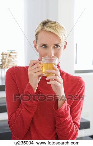 Picture - Close-up of a woman holding a cup of tea. Fotosearch