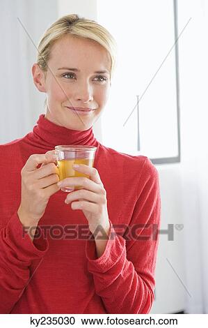 Close-up of a woman holding a cup of tea View Large Photo Image Stock Image - Close-up of a woman holding a cup of tea. Fotosearch
