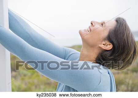 Close-up of a woman smiling View Large Photo Image Stock Photo - Close-up of a woman smiling. Fotosearch