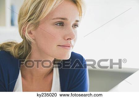 Stock Image - Close-up of a woman thinking. Fotosearch