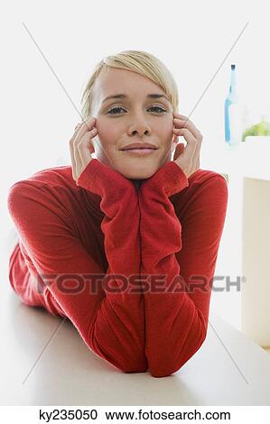 Stock Image - Portrait of a woman lying on the floor. Fotosearch