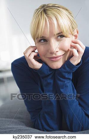 Woman lying on the bed and smiling View Large Photo Image Stock Photo - Woman lying on the bed and smiling. Fotosearch