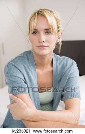 Woman sitting on the bed and thinking View Large Photo Image Stock Image - Woman sitting on the bed and thinking. Fotosearch