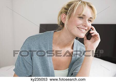 Woman talking on a mobile phone View Large Photo Image Stock Image - Woman talking on a mobile phone. Fotosearch