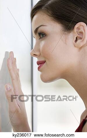 Close-up of a fashion model looking at her reflection View Large Photo Image Stock Photo - Close-up of a fashion model looking at her reflection. Fotosearch
