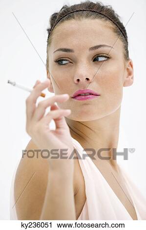 Close-up of a woman smoking a cigarette View Large Photo Image Stock Image - Close-up of a woman smoking a cigarette. Fotosearch