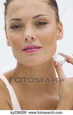 Fashion model applying perfume View Large Photo Image Stock Photograph - Fashion model applying perfume. Fotosearch