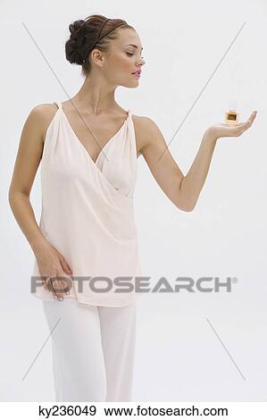 Stock Photo - Fashion model holding a perfume bottle. Fotosearch
