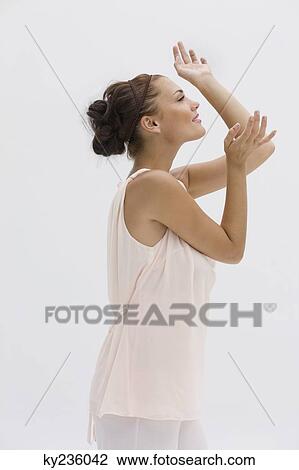 Fashion model posing with her arms raised View Large Photo Image Stock Image - Fashion model posing with her arms raised. Fotosearch