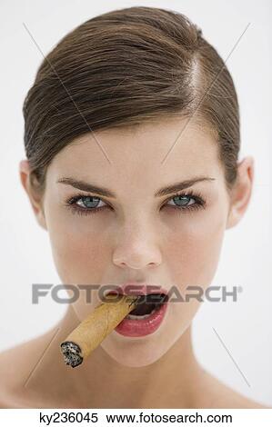 Portrait of a fashion model smoking a cigar View Large Photo Image Stock Photography - Portrait of a fashion model smoking a cigar. Fotosearch