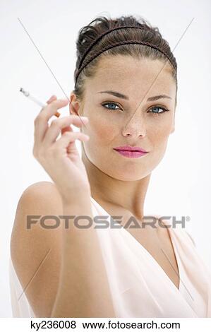Portrait of a woman smoking a cigarette View Large Photo Image Stock Photo - Portrait of a woman smoking a cigarette. Fotosearch