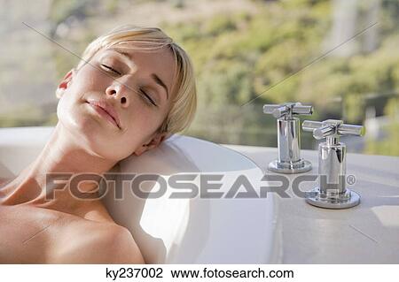 Close-up of a woman in a bathtub View Large Photo Image Stock Image - Close-up of a woman in a bathtub. Fotosearch
