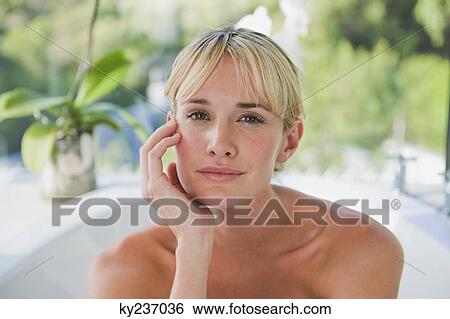Stock Photograph - Portrait of a woman in a bathtub. Fotosearch