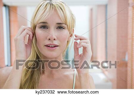 Woman adjusting her hair View Large Photo Image Stock Image - Woman adjusting her hair. Fotosearch