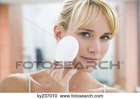 Woman applying face powder View Large Photo Image Stock Image - Woman applying face powder. Fotosearch