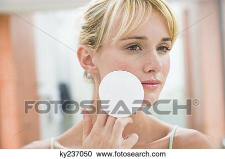 Woman applying face powder View Large Photo Image Stock Image - Woman applying face powder. Fotosearch