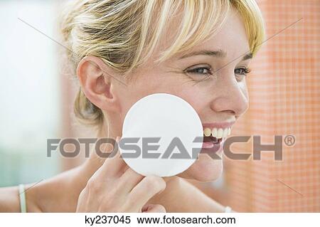 Woman applying face powder View Large Photo Image Stock Photography - Woman applying face powder. Fotosearch