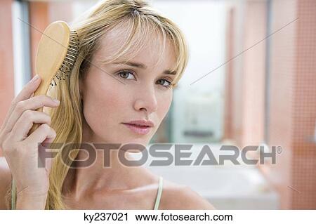 Woman brushing her hair View Large Photo Image Stock Image - Woman brushing her hair. Fotosearch