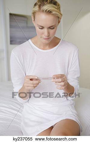 Stock Photography - Woman holding a blister pack of medicine. Fotosearch