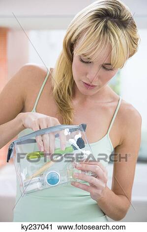 Woman holding a make-up bag View Large Photo Image Stock Image - Woman holding a make-up bag. Fotosearch