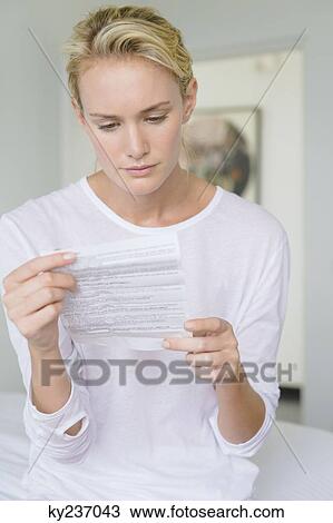 Woman reading a medical report View Large Photo Image Stock Image - Woman reading a medical report. Fotosearch