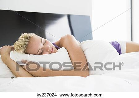 Woman sleeping on the bed View Large Photo Image Picture - Woman sleeping on the bed. Fotosearch