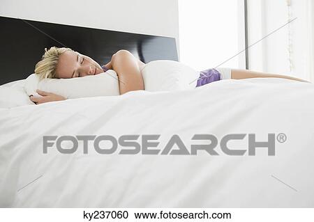 Woman sleeping on the bed View Large Photo Image Stock Image - Woman sleeping on the bed. Fotosearch