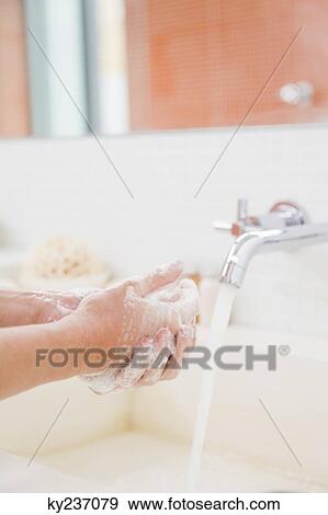Woman washing hands in the bathroom View Large Photo Image Stock Photo - Woman washing hands in the bathroom. Fotosearch