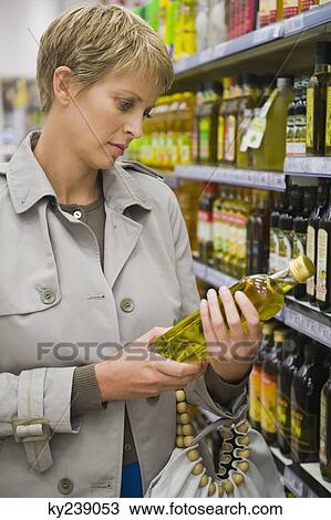 Woman buying beverages in a store View Large Photo Image Stock Image - Woman buying beverages in a store. Fotosearch