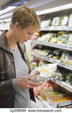 Woman buying packed food in a supermarket View Large Photo Image Stock Photo - Woman buying packed food in a supermarket. Fotosearch